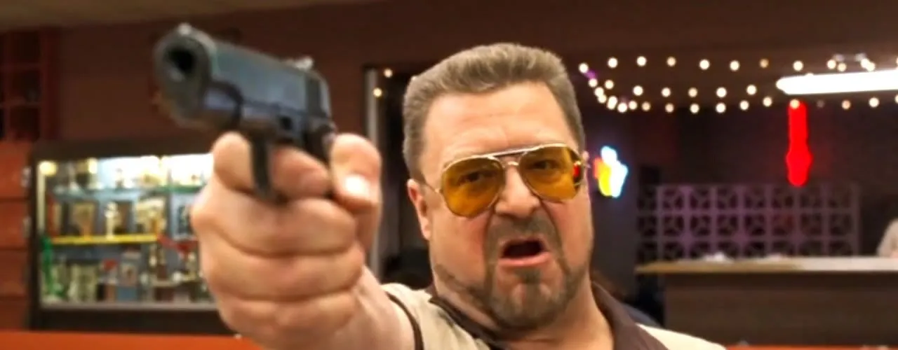 Walter Sobchak points his pistol in the bowling alley, the 'mark it zero' scene from The Big Lebowski