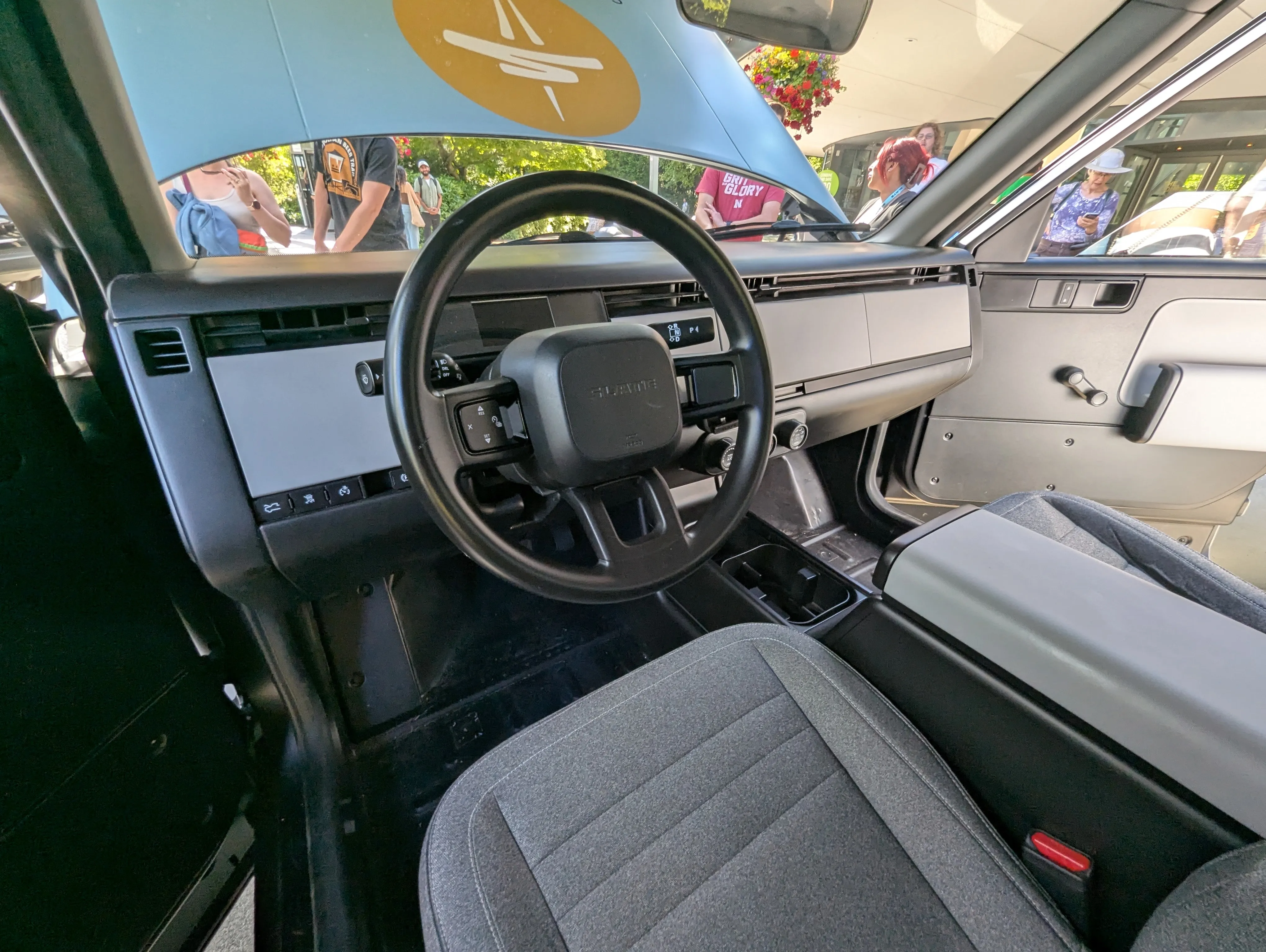 The Slate Truck's bare interior — a flat dash with no center touchscreen, manual controls and cloth seats